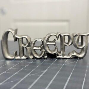 Silver Metal CREEPY Cutout Tabletop Sign by Makers Halloween
